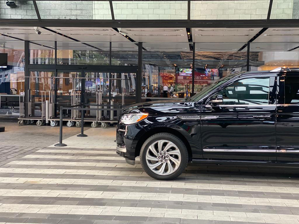 Black SUV waiting outside a hotel for airport car service