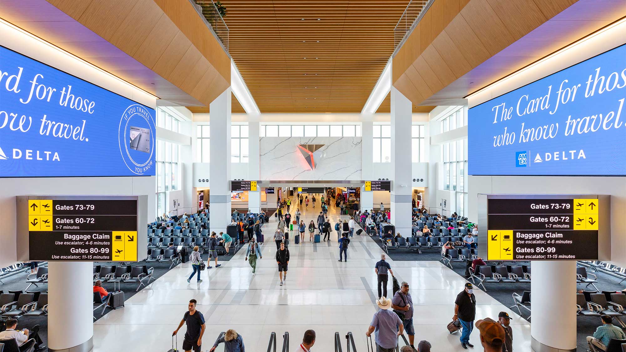 Modern LaGuardia Airport Terminal C interior with travelers and signage